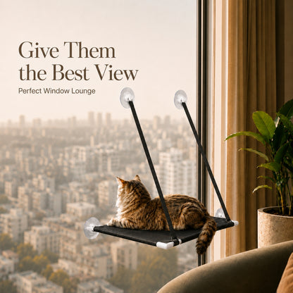 A brown tabby cat lies on a black window-mounted pet lounger with suction cups, overlooking a city skyline. Text on the left reads 'Give Them the Best View' and 'Perfect Window Lounge.